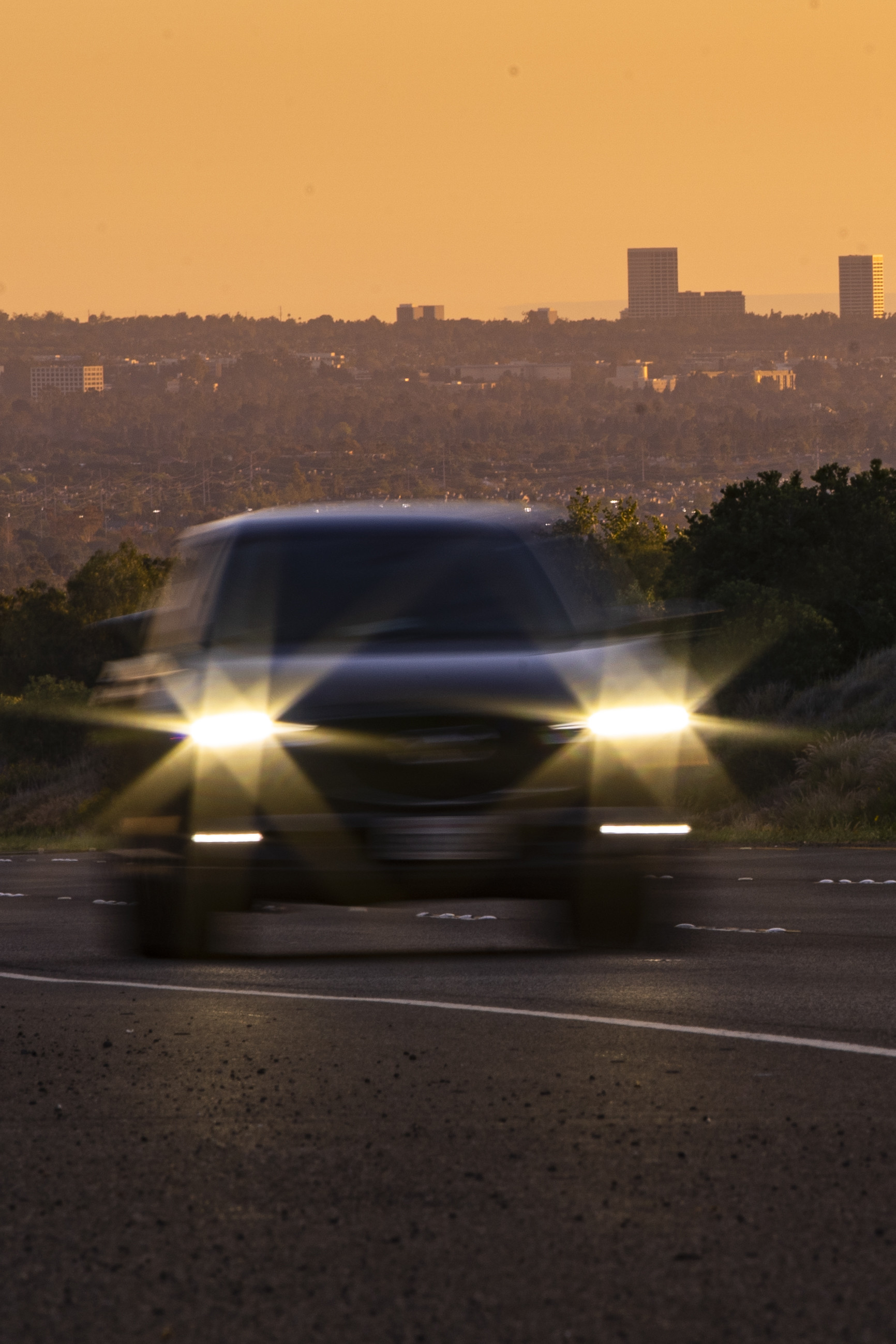 Photo of a car driving on the 73 Toll Road at dusk.