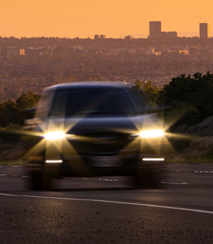 Photo of a car driving on the 73 Toll Road at dusk.
