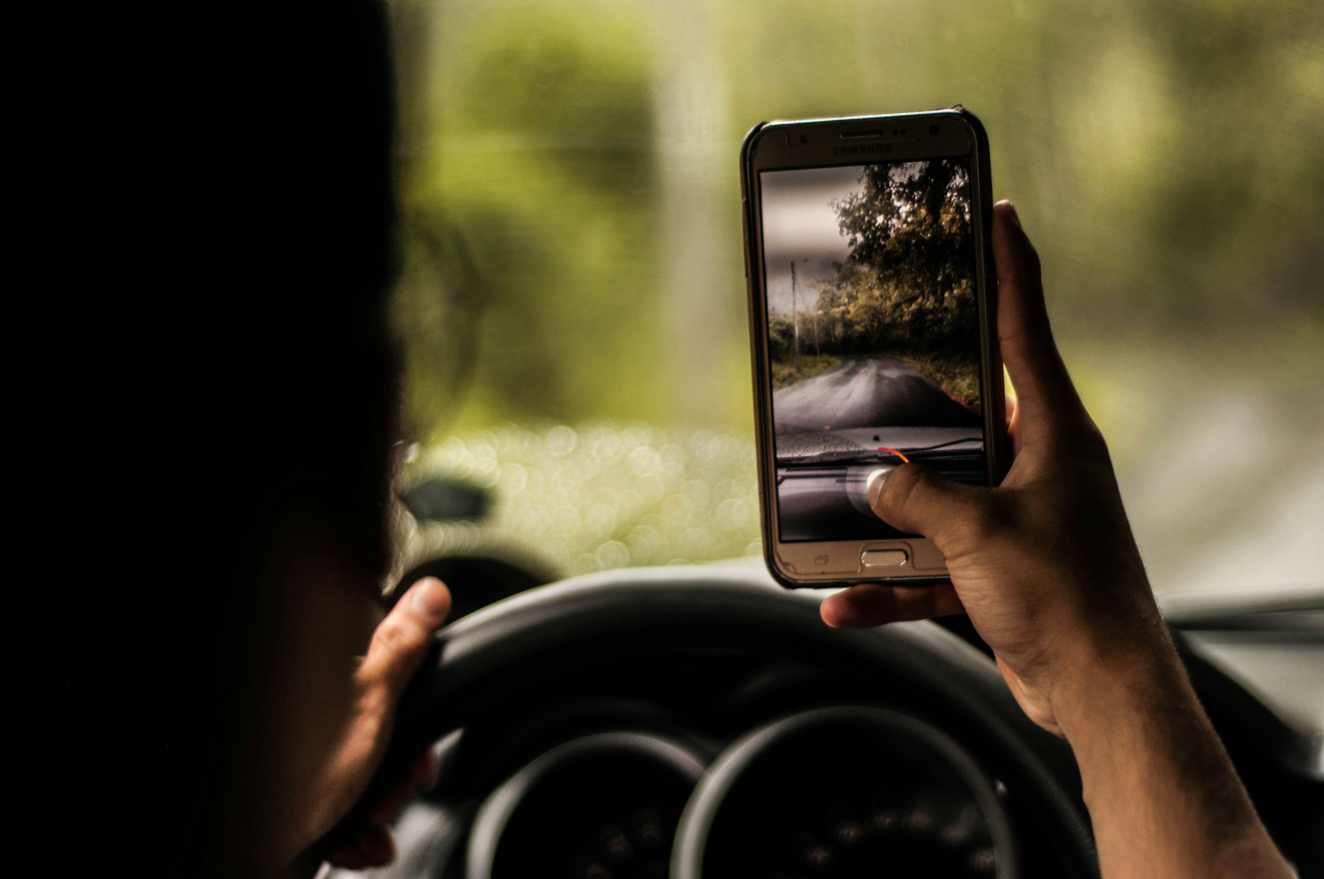 Image of a person taking a photo while driving