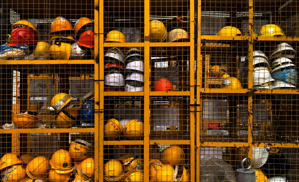 Photo of various hard hats in a work locker