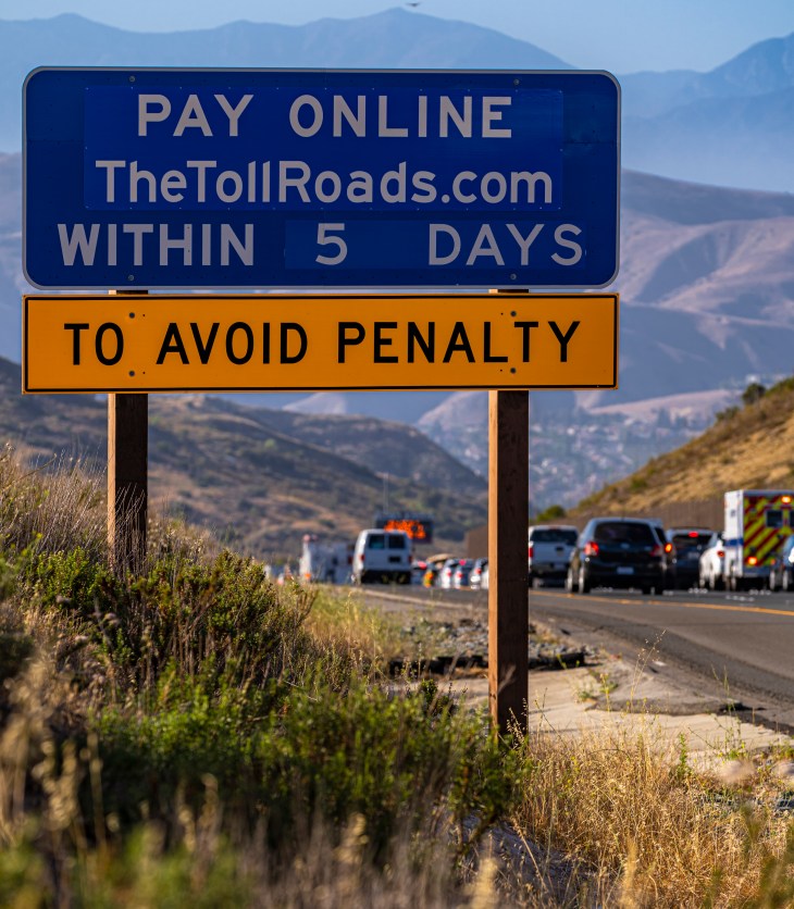 Road sign that reads "Pay Online TheTollRoads.com within 5 days to avoid penalty"