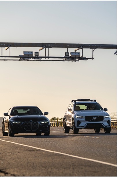 Photo of two cars through a tolling point
