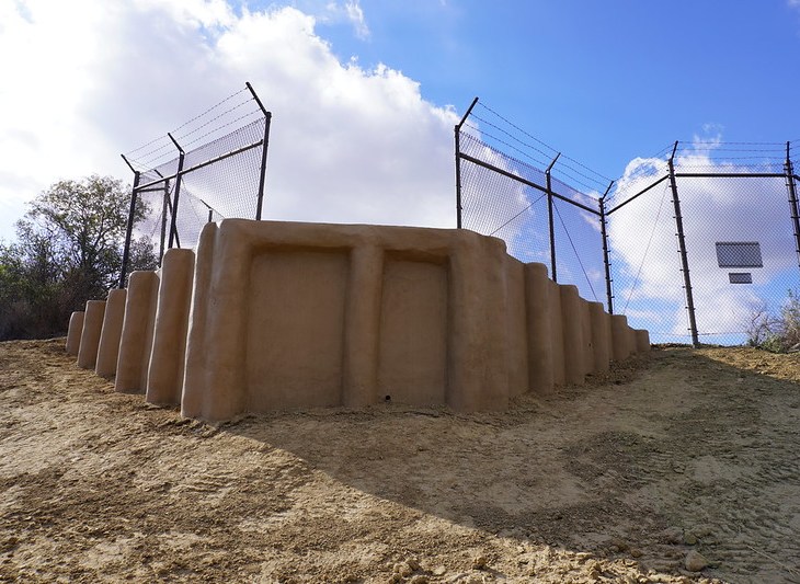A view of a jump-out ramp and fence from the open space side.