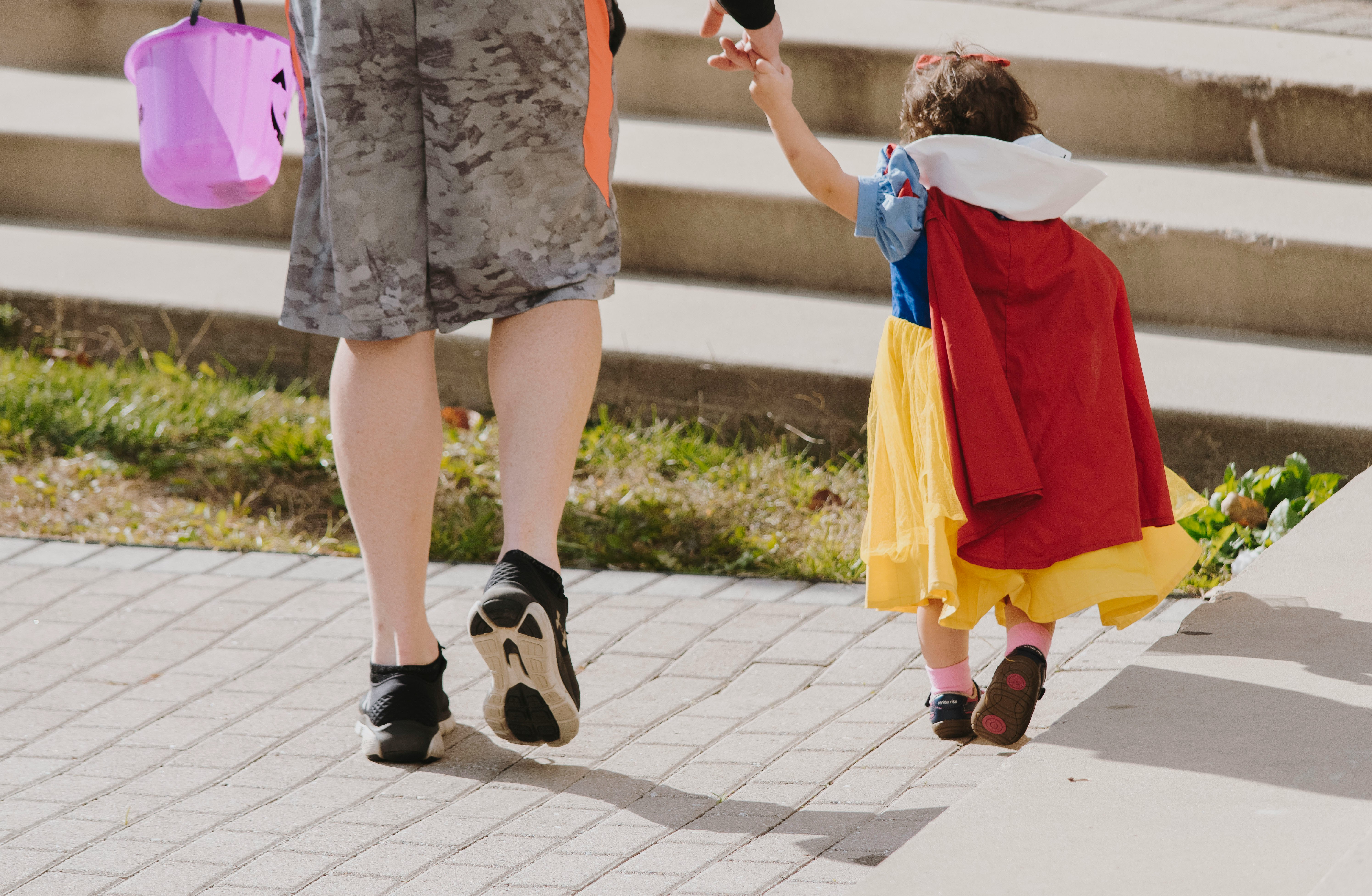 Trick or treating parent and child during the daytime